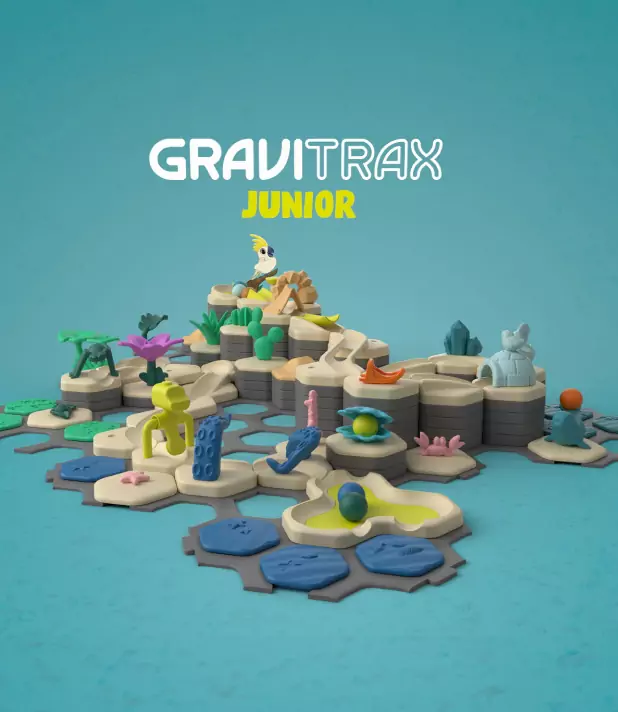GraviTrax Junior Baukasten auf blauem Hintergrund, mit bunten Elementen und Tieren für kreatives Spiel und Spaß.
