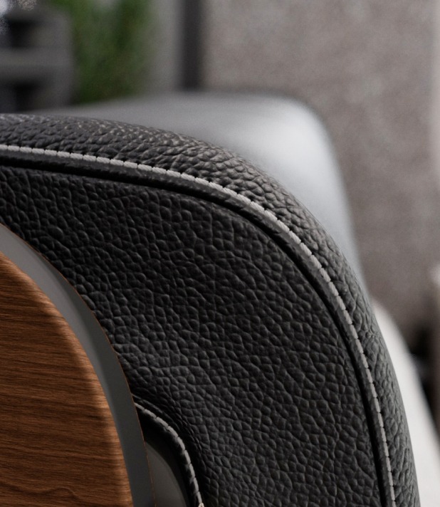 Schwarzer Ledersessel mit detaillierter Naht und Holzarmlehne, modernes Interieur Design.