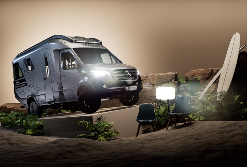 Offroad-Campingbus im Gelände mit Surfbrett und Stühlen, ideal für Abenteuerreisen und Naturerlebnisse.